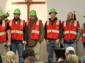 Members of a mine rescue team who work with Pete Kuhn stand at his memorial ceremony.