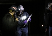 Amadeusz Lord and Justin Bollini confer during a training scenario as member of the Rescue Dawgs mining team.
