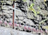 A cross and flags are seen overlooking the Avondale mine site in Plymouth Township.