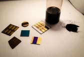 Sample of pulverized coal (right) is shown with several test devices made from coal by the MIT researchers.