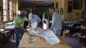 Black Hills Mining Museum Dave Reddick, Jerry Pontius, and Mike Stahl work on mounting the new sign for the facility.