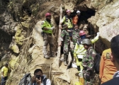 Rescuers stand at the entrance of a collapsed mine in Bolaang Mongondow, North Sulawesi, Indonesia.