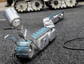 The snake robot fits into a 4-inch-wide bore hole to gather information needed in a mine rescue. (Photo: Pam Panchak)