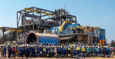 Workers gather around the concentrator’s ball mill to celebrate the restart of the Kipushi mine