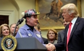 Michael Nelson, a coal miner worker shakes hands with U.S. President Donald Trump. REUTERS/Carlos Barria
