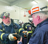 Radios are distributed to rescuers during a mine emergency response drill at Harvey Mine on Friday. (Photo: Karen Mansfield)