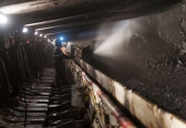 A coal miner works in a longwall mining tunnel at the Consol Energy Bailey Mine in Wind Ridge, Pa., May 14, 2013.