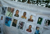 A banner with photos of several missing miners hangs on a tree near Tumeremo, Venezuela,