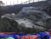 A man sits on giant jade stone at a mine in Phakant, Kachin State, northern Burma.
