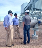 Steven Winberg speaks with Wyoming Sen. Mike Enzi while taking a tour of the Integrated Test Center in Gillette.