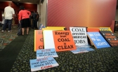 Signs supporting coal production are left outside a scoping meeting at the Salt Palace Convention Center. (Photo: Chris Samuels)