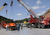Crews begin to move in heavy machinery to the 2017 Bluefield Coal Show at the Brushfork National Guard Armory Friday.