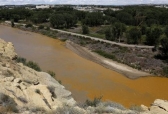 Water from the Animas River mixes with the San Juan River on Aug. 8, 2015, shortly after the Gold King Mine spill.