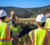 Matt Zietlow stands atop a reclaimed former pit mine and talks about ongoing reclamation efforts at the mine.