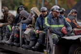 In this Oct. 15, 2014 photo, coal miners return on a buggy after working a shift underground at the Perkins Branch Coal Mine.