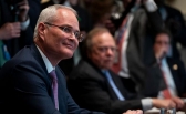 Exxon Mobil CEO Darren Woods listens as President Donald Trump speaks during a meeting with energy sector leaders.