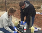 Graduate student Kaela Amundson and Michael Wilkins filtering produced hydraulic fracturing fluids in the field.