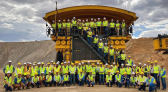 Customers, distributors gathered in front of Komatsu's 980E-5AT truck at the company's Automation Global User Forum