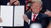 President Trump holds up a signed proclamation to shrink the size of Bears Ears and Grand Staircase-Escalante monuments.