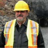 Frank Basa, chief executive of Canada Cobalt Works, poses outside the 100-year-old Castle Mine.(photo: Carly Thomas, CBC)