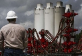 A WildHorse Resource Development employee overlooks fracking operations outside Caldwell.